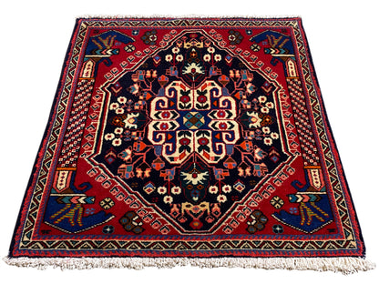 Tapete Poshti 66x63 cm, azul-escuro/vermelho, padrão de medalhão com franjas nas extremidades