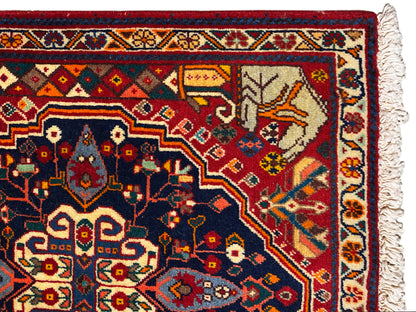 Close-up of the edge of the carpet with a blue ornamental field, red details and fringes
