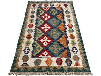 Boho Kelim Teppich grün mit farbigen geometrischen Motiven